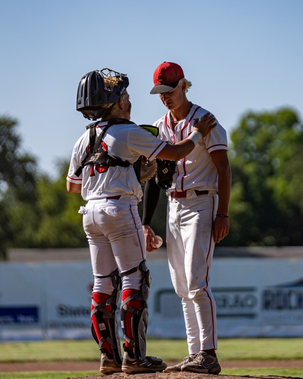 Chico catcher Ryan Heym, left, consoles starting pitcher Carter Miles,...