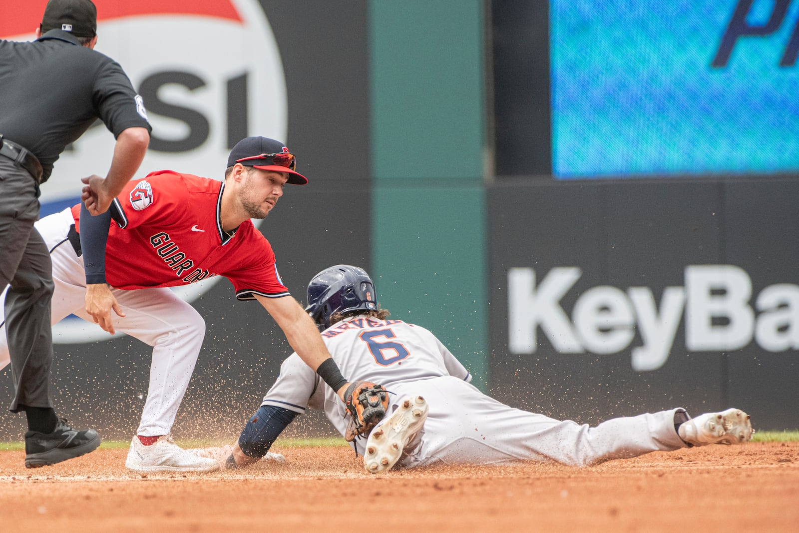 Cleveland Guardians' Will Wilson, left, is late with a tag as Houston Astros' Jake Meyers steals second during the second inning of a baseball game, Sunday June 8, 2025, in Cleveland. (AP Photo/Phil Long)