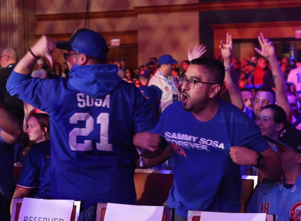 Cubs fans Eddie Garcia, left, and David Berreles show off...
