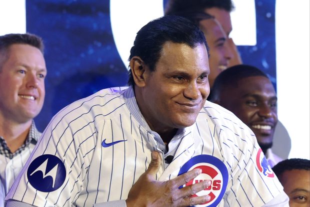Former Cubs player Sammy Sosa acknowledges fans as he is...