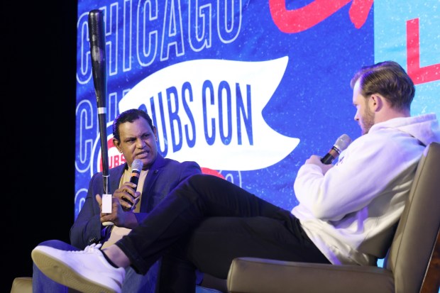 Former Cubs player Sammy Sosa, left, discusses his batting grip...