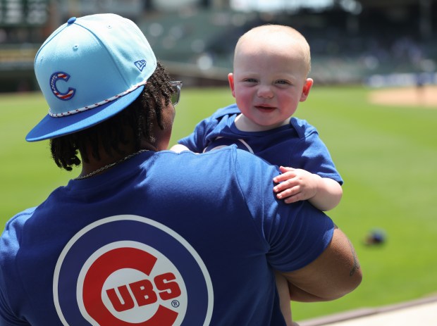 Ivory Mamo holds her 11-month-old nephew, Sawyer, before a Cubs-Mariners game on June 21, 2025, at Wrigley Field. (John J. Kim/Chicago Tribune)
