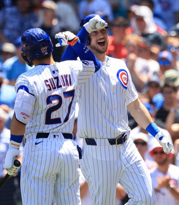 Cubs right fielder Kyle Tucker celebrates with Seiya Suzuki after hitting a home run against the Mariners in the first inning on June 21, 2025, at Wrigley Field. (John J. Kim/Chicago Tribune)