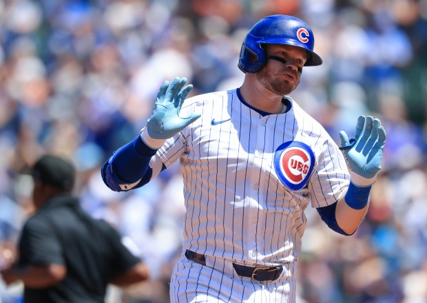 Cubs left fielder Ian Happ rounds the bases after hitting a three-run home run against the Mariners in the second inning on June 21, 2025, at Wrigley Field. (John J. Kim/Chicago Tribune)