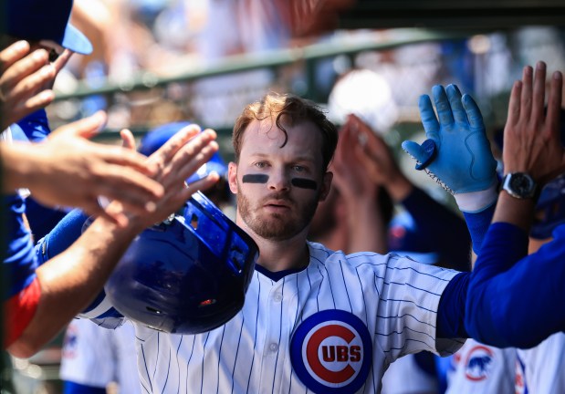 Cubs left fielder Ian Happ is congratulated after hitting a three-run home run against the Mariners in the second inning on June 21, 2025, at Wrigley Field. (John J. Kim/Chicago Tribune)