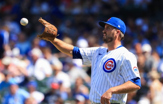 Cubs reliever Drew Pomeranz retrieves the ball after giving up a two-run single in the fifth inning against the Mariners on June 21, 2025, at Wrigley Field. (John J. Kim/Chicago Tribune)