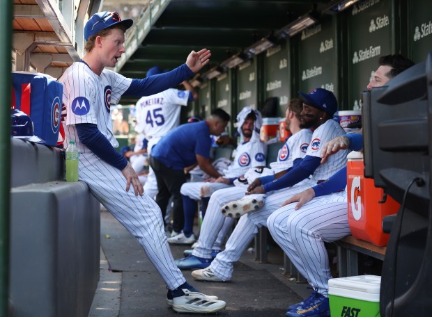 Cubs center fielder Pete Crow-Armstrong, left, talks with teammates in the dugout during a temporary stoppage in play in the sixth inning against the Mariners on June 21, 2025, at Wrigley Field. (John J. Kim/Chicago Tribune)
