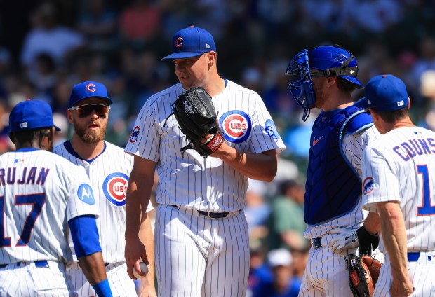 Cubs reliever Brad Keller, center, stands on the mound before being taken out of the game in the seventh inning against the Mariners on June 21, 2025, at Wrigley Field. (John J. Kim/Chicago Tribune)