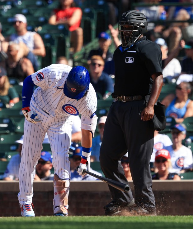 Cubs designated hitter Seiya Suzuki slams his bat on the ground as he is called out on strikes in the eighth inning against the Mariners on June 21, 2025, at Wrigley Field. Suzuki went 0-for-5 in the game. (John J. Kim/Chicago Tribune)