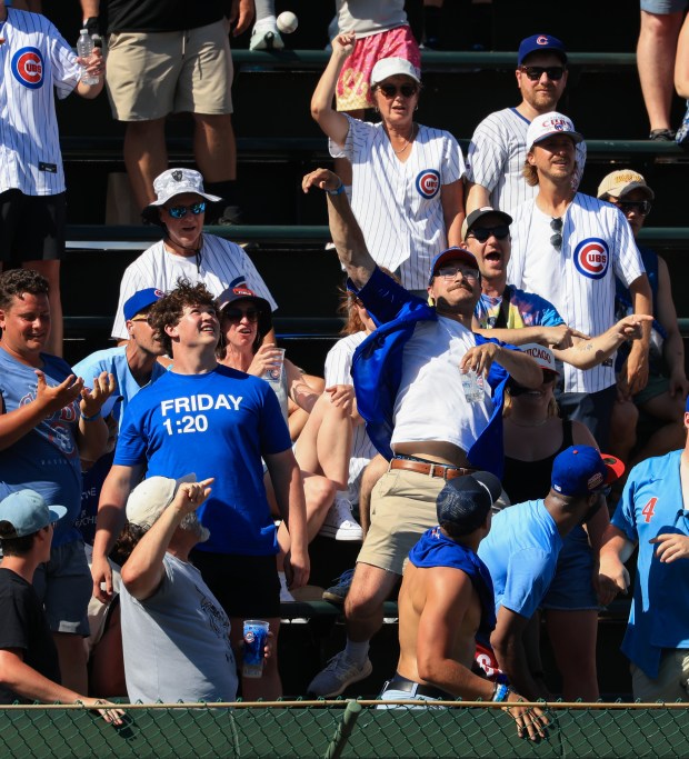 A Cubs fan throws back a home run ball hit by Mariners catcher Cal Raleigh in the ninth inning against the Cubs on June 21, 2025, at Wrigley Field. (John J. Kim/Chicago Tribune)
