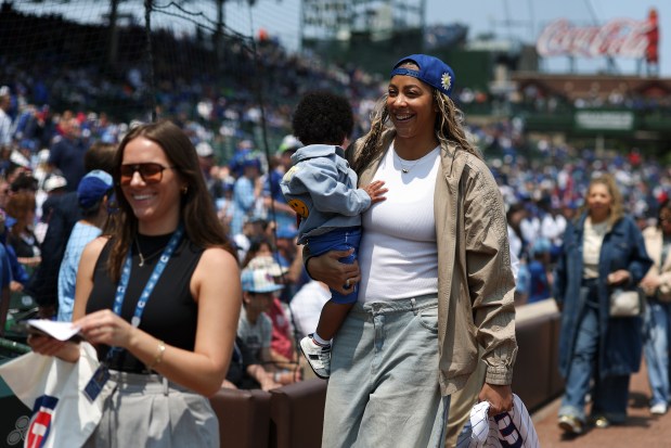 Retired WNBA player Candace Parker walks onto the field to throw out the first pitch before the Chicago Cubs game against the Cincinnati Reds at Wrigley Field on Sunday, June 1, 2025. (Eileen T. Meslar/Chicago Tribune)