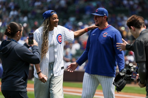 Retired WNBA player Candace Parker speaks to Chicago Cubs pitcher Brad Keller (40) after throwing out the first pitch before the Chicago Cubs game against the Cincinnati Reds at Wrigley Field on Sunday, June 1, 2025. (Eileen T. Meslar/Chicago Tribune)