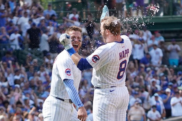 The Cubs' Ian Happ, right, celebrates after his walk-off single with Nico Hoerner on Sunday, June 15, 2025, at Wrigley Field. (AP Photo/David Banks)
