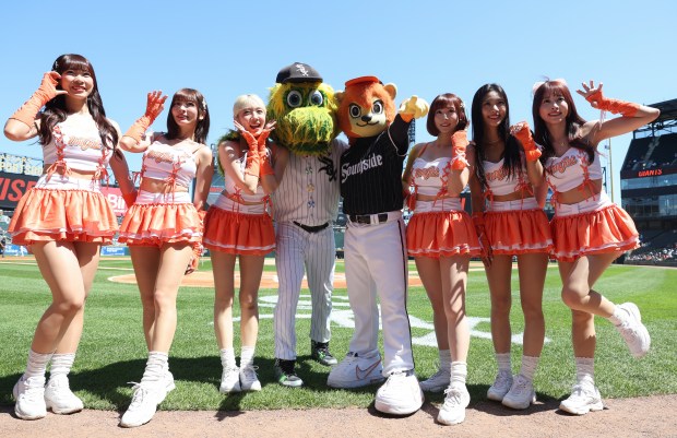 Members of a Taiwanese cheerleading squad named "Uni-Girls" pose for pictures with White Sox mascot Southpaw on Taiwan Day at Rate Field before a White Sox-Giants game Saturday, June 28, 2025. (John J. Kim/Chicago Tribune)
