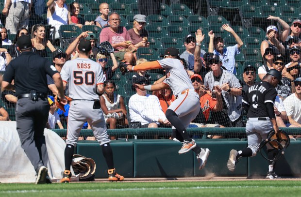 Giants left fielder Heliot Ramos bounces off the safety netting after catching a fly ball by White Sox left fielder Andrew Benintendi in the third inning Saturday, June 28, 2025, at Rate Field. (John J. Kim/Chicago Tribune)