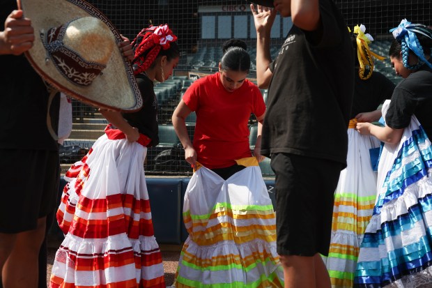 Members of Ballet Folklorico de Chicago get into their performance attire before a White Sox-Royals game on Mexican Heritage Night at Rate Field on June 6, 2025. (John J. Kim/Chicago Tribune)
