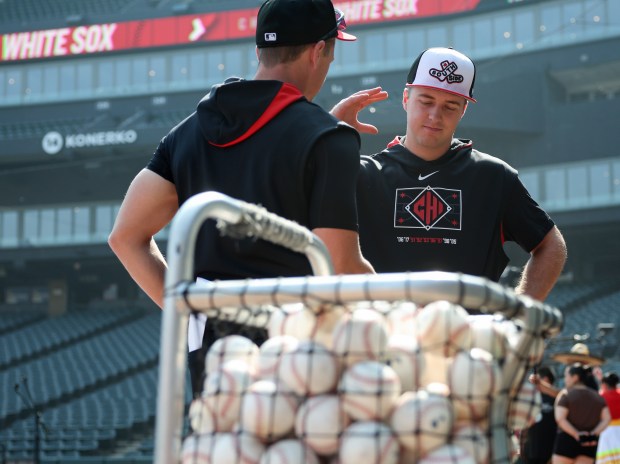 White Sox catcher Kyle Teel, right, thanks bench coach Walker McKinven while talking before a game against the Royals on June 6, 2025, at Rate Field. (John J. Kim/Chicago Tribune)
