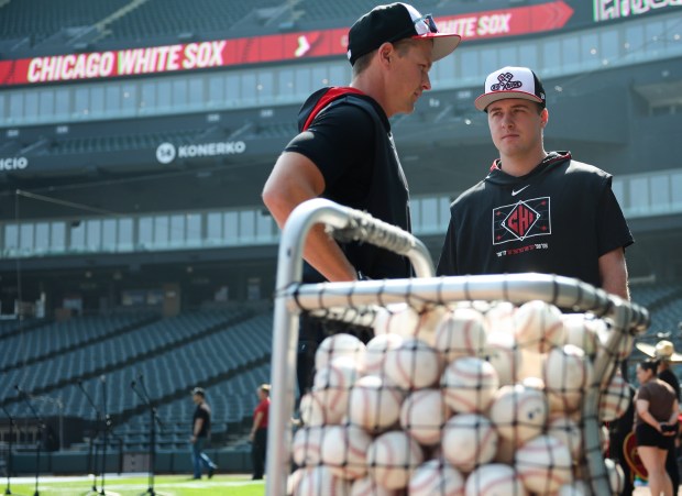 White Sox catcher Kyle Teel, right, talks with bench coach Walker McKinven before a game against the Royals on June 6, 2025, at Rate Field. Teel was called up earlier in the day for his major-league debut. (John J. Kim/Chicago Tribune)