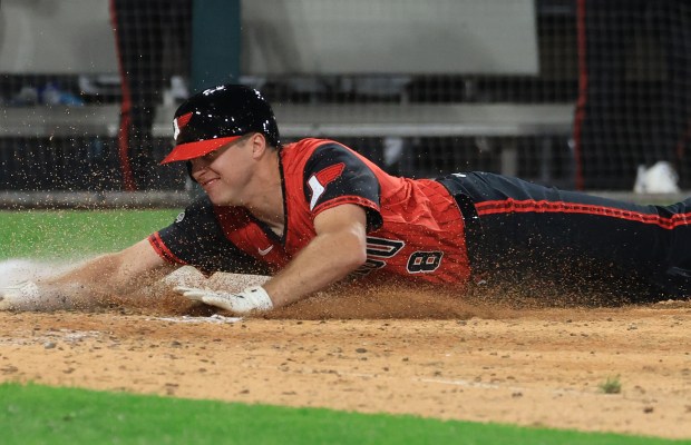 White Sox catcher Kyle Teel dives for the plate to score on a wild pitch in the eighth inning against the Royals at Rate Field on June 6, 2025, in Chicago. (John J. Kim/Chicago Tribune)