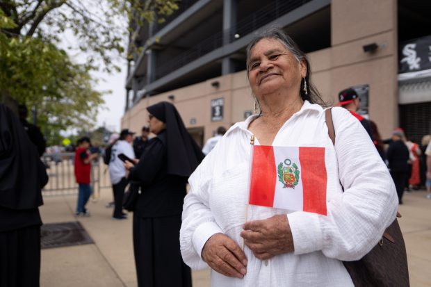 Maria Alarcon Monteza, of Chiclayo, Peru, poses for a portrait while waiting to enter Rate Field before celebrating the election of Pope Leo XIV with a citywide gathering and Catholic Mass on June 14, 2025. (Audrey Richardson/Chicago Tribune)