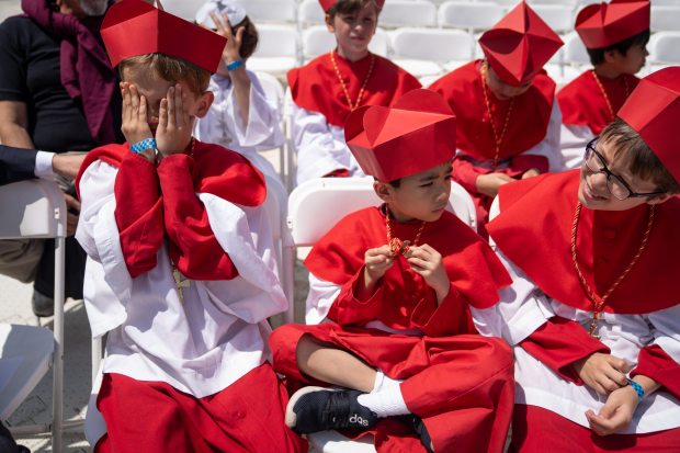 Members of Our Lady of Mount Carmel Academy, Eli Allen, 9, left, and Johan Lin, 7, sit before programming begins during a celebration of the election of Pope Leo XIV with a citywide gathering and Catholic Mass at Rate Field on June 14, 2025. (Audrey Richardson/Chicago Tribune)