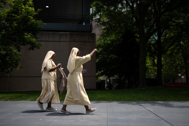 Members of Little Sisters of St. Francis walk towards Rate Field before celebrating the election of Pope Leo XIV with a citywide gathering and Catholic Mass on June 14, 2025. (Audrey Richardson/Chicago Tribune)