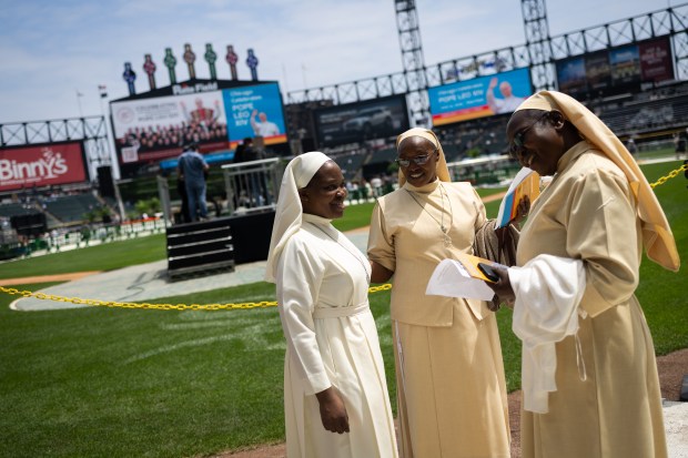 Sister Max Nanyanzi, of Immaculate Heart of Mary Reparatrix, left, Sister Bernadette Wanza, of Little Sisters of St. Francis, and Sister Mary Njane, of Little Sisters of St. Francis, enter Rate Field before celebrating the election of Pope Leo XIV with a citywide gathering and Catholic Mass on June 14, 2025. (Audrey Richardson/Chicago Tribune)