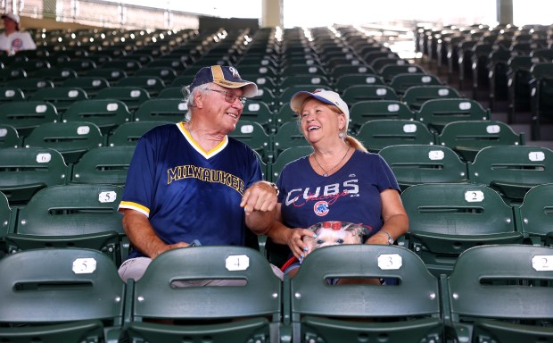 Brewers fan Duane Wiegel and Cubs fan Diane Wilcoxen share a moment as they wait for the teams to face off Tuesday, June 17, 2025, at Wrigley Field. (Chris Sweda/Chicago Tribune)