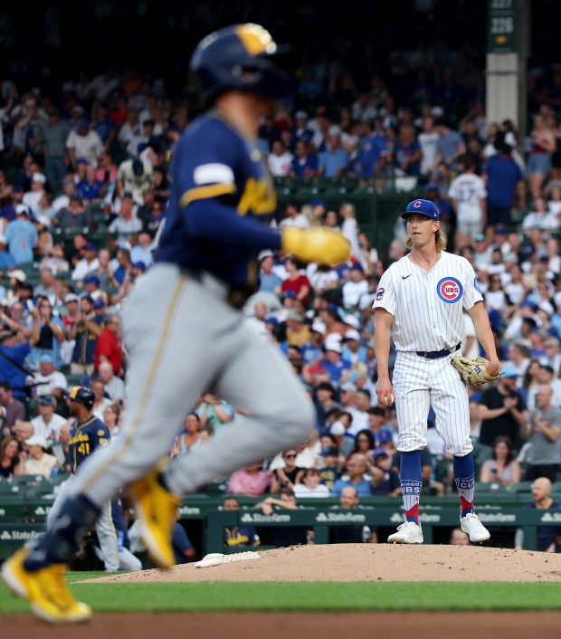 Cubs starter Ben Brown stands on the mound as Brewers left fielder Isaac Collins (foreground) rounds the bases after hitting a two-run home run in the second inning Tuesday, June 17, 2025, at Wrigley Field. (Chris Sweda/Chicago Tribune)