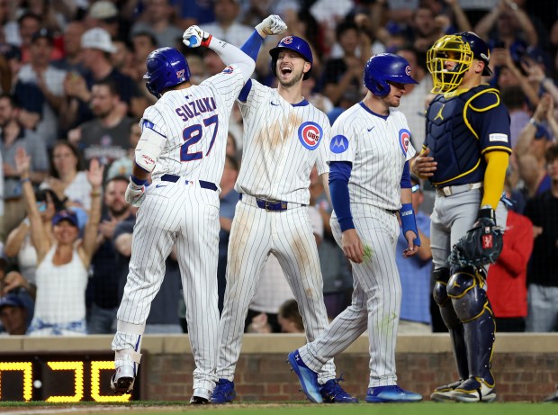 Cubs designated hitter Seiya Suzuki (27) is congratulated by teammate Kyle Tucker after Suzuki hit a three-run home run in the fifth inning against the Brewers on Tuesday, June 17, 2025, at Wrigley Field. (Chris Sweda/Chicago Tribune)