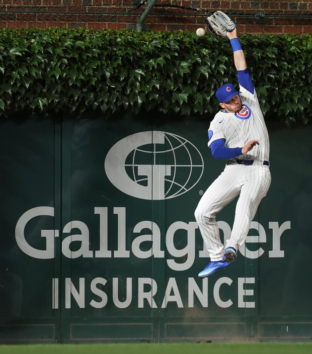 Cubs left fielder Ian Happ is unable to catch a long fly ball in the ninth inning against the Brewers on Tuesday, June 17, 2025, at Wrigley Field. (Chris Sweda/Chicago Tribune)