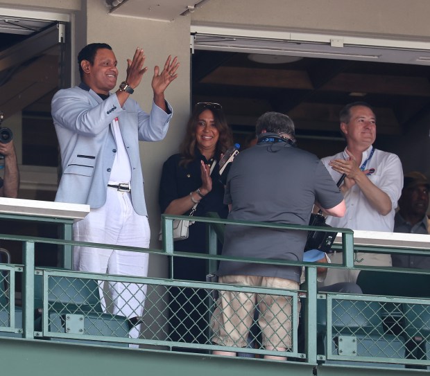 Former Cubs slugger Sammy Sosa acknowledges applause from fans as...