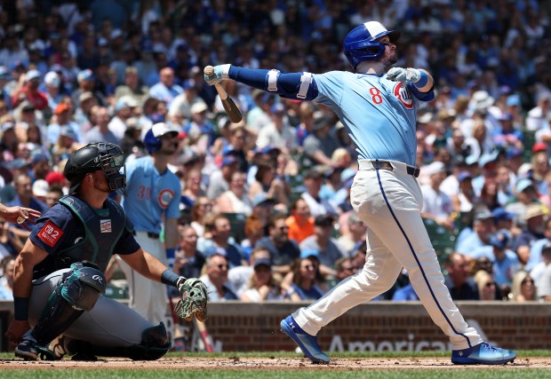 Cubs left fielder Ian Happ follows through on a solo home run in the first inning against the Mariners on June 20, 2025, at Wrigley Field. (Chris Sweda/Chicago Tribune)