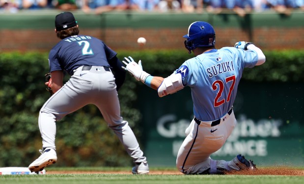Cubs designated hitter Seiya Suzuki slides into second base with a double in the first inning against the Mariners on Friday, June 20, 2025, at Wrigley Field. (Chris Sweda/Chicago Tribune)