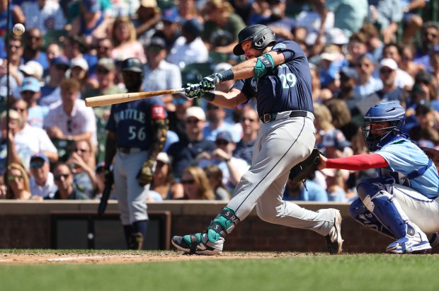 Mariners catcher Cal Raleigh hits a two-run home run in the seventh inning against the Cubs on Friday, June 20, 2025, at Wrigley Field. (Chris Sweda/Chicago Tribune)