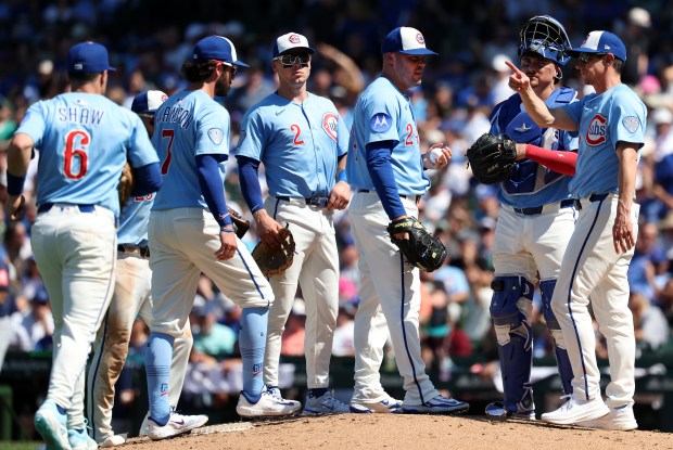 Cubs manager Craig Counsell makes a call to the bullpen as he pulls reliever Caleb Thielbar in the seventh inning against the Mariners on Friday, June 20, 2025, at Wrigley Field. (Chris Sweda/Chicago Tribune)