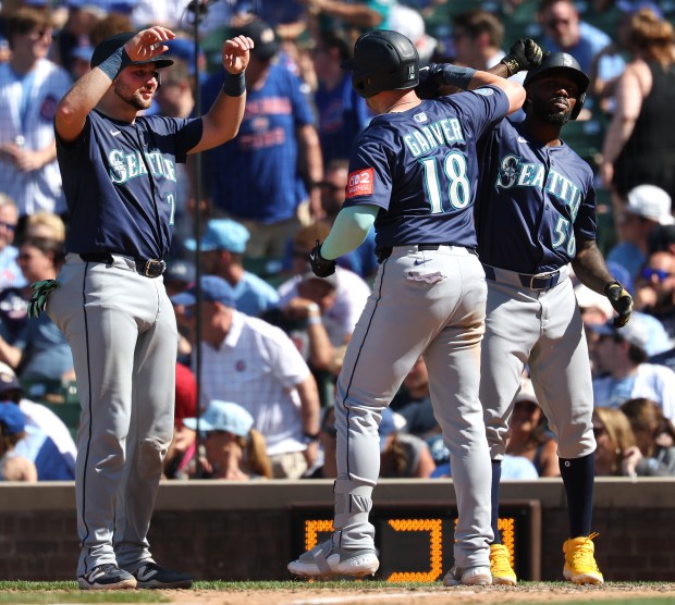 Mariners designated hitter Mitch Garver is congratulated by teammates after hitting a three-run home run in the ninth inning against the Cubs on Friday, June 20, 2025, at Wrigley Field. (Chris Sweda/Chicago Tribune)