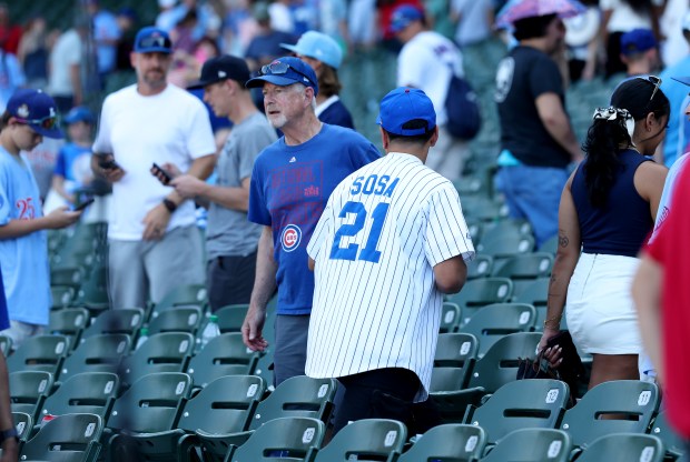 A Cubs fan wearing a Sammy Sosa jersey exits the ballpark after the Cubs' 9-4 loss to the Mariners on Friday, June 20, 2025, at Wrigley Field. (Chris Sweda/Chicago Tribune)