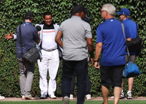 Former Cubs slugger Sammy Sosa poses beside the ivy in...