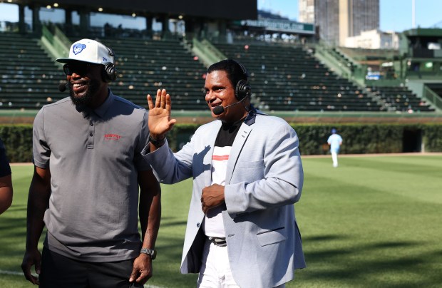 Former Cubs slugger Sammy Sosa waves while doing a television...