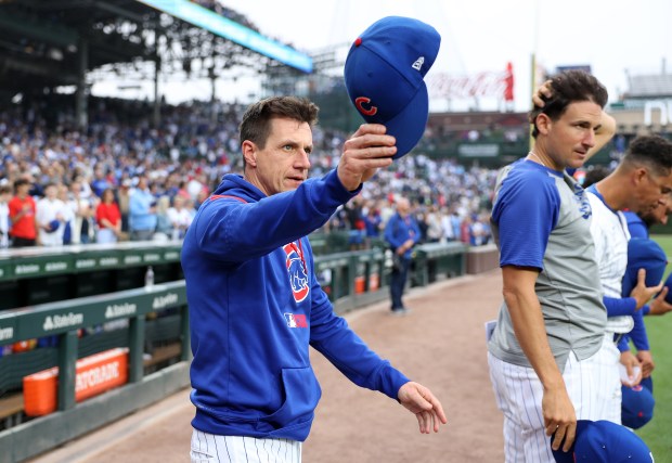 Cubs manager Craig Counsell waves to Pirates coaches while walking out for the national anthem before a game on June 12, 2025, at Wrigley Field. (Chris Sweda/Chicago Tribune)