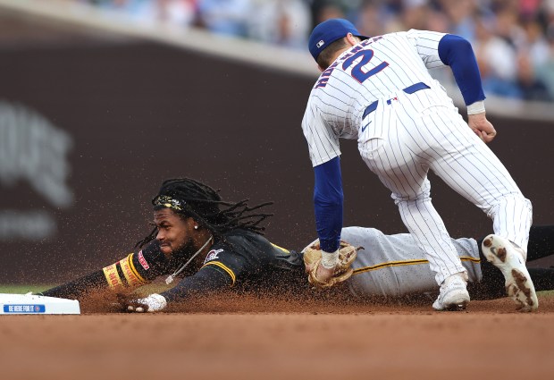 Cubs second baseman Nico Hoerner (2) tags out Pirates center fielder Oneil Cruz at second base on a steal attempt in the third inning on June 12, 2025, at Wrigley Field. (Chris Sweda/Chicago Tribune)