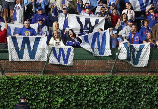 Fans in the left-field bleachers celebrate after the Cubs' 3-2 victory over the Pirates on June 12, 2025, at Wrigley Field. (Chris Sweda/Chicago Tribune)