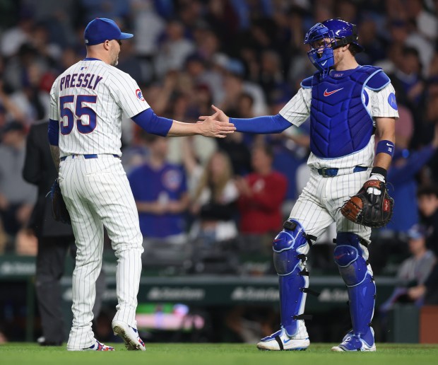 Cubs reliever Ryan Pressly (55) and catcher Carson Kelly celebrate after securing a victory by closing out the Pirates in the ninth inning on June 12, 2025, at Wrigley Field. (Chris Sweda/Chicago Tribune)
