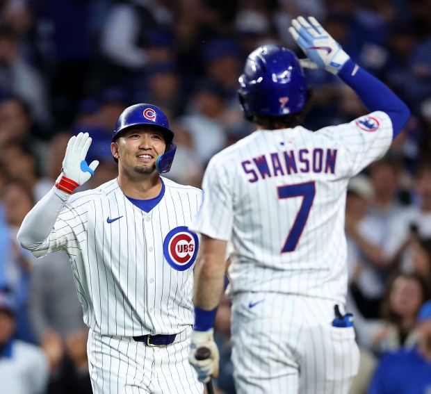 Cubs designated hitter Seiya Suzuki, left, celebrates with Dansby Swanson after hitting a solo home run in the sixth inning against the Pirates on June 12, 2025, at Wrigley Field. (Chris Sweda/Chicago Tribune)