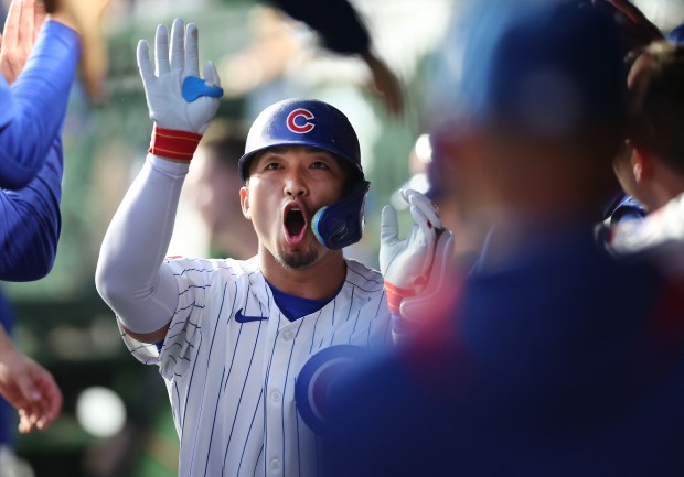 Cubs designated hitter Seiya Suzuki celebrates with teammates in the dugout after hitting a solo home run in the sixth inning against the Pirates on June 12, 2025, at Wrigley Field. (Chris Sweda/Chicago Tribune)