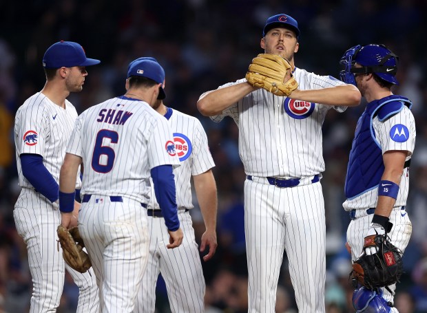 Cubs starter Jameson Taillon, second from right, stands on the mound before being pulled from the game with one out in the top of the seventh inning against the Pirates on June 12, 2025, at Wrigley Field. (Chris Sweda/Chicago Tribune)
