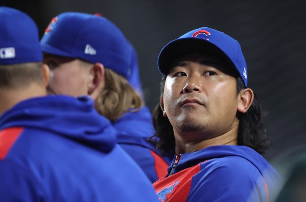 Injured Chicago Cubs pitcher Shota Imanaga looks out from the dugout in the seventh inning of a game against the Colorado Rockies at Wrigley Field in Chicago on May 27, 2025. (Chris Sweda/Chicago Tribune)