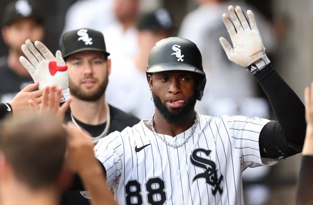 Chicago White Sox center fielder Luis Robert Jr. is congratulated in the dugout after hitting a solo home run in the second inning of a game against the Arizona Diamondbacks at Rate Field in Chicago on June 24, 2025. (Chris Sweda/Chicago Tribune)