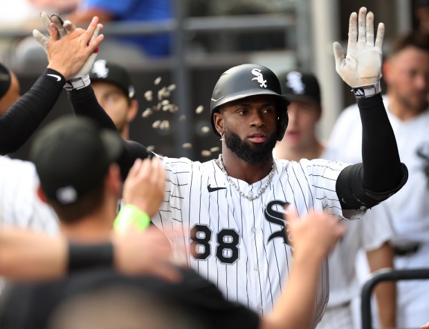 Chicago White Sox center fielder Luis Robert Jr. is congratulated in the dugout after hitting a solo home run in the second inning of a game against the Arizona Diamondbacks at Rate Field in Chicago on June 24, 2025. (Chris Sweda/Chicago Tribune)